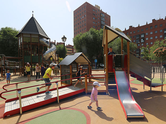 children playing on an inclusive playground multi-play unit featuring a ramp